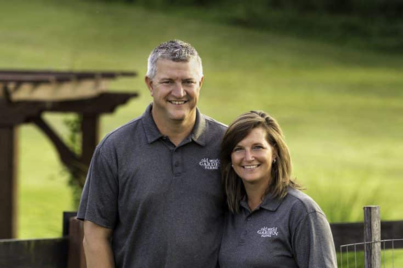 jim and mary standing together in front of a fence