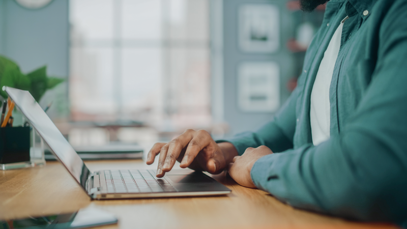 person typing on a laptop at a desk
