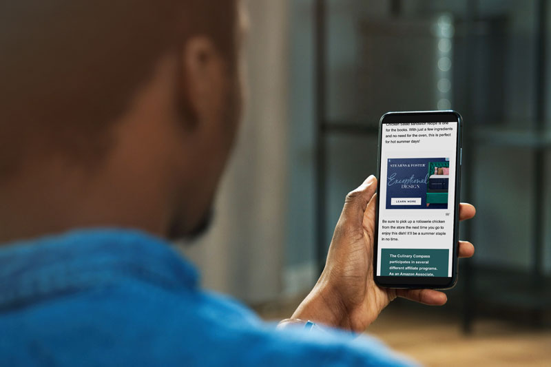 man looking at phone with ad reporter on it