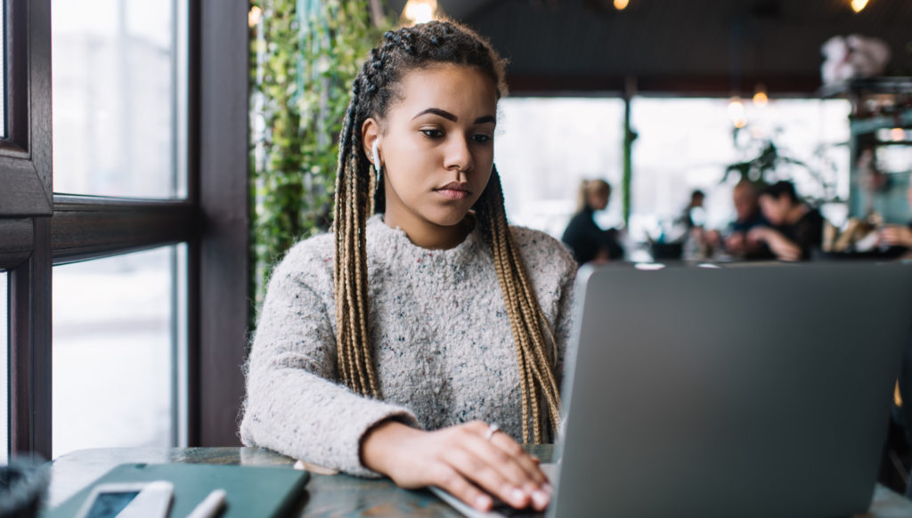woman concentrating on her laptop in a workspace