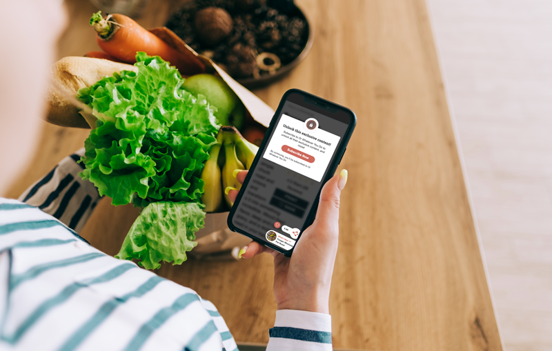 exclusive content shown on a phone being used by a person preparing to cook